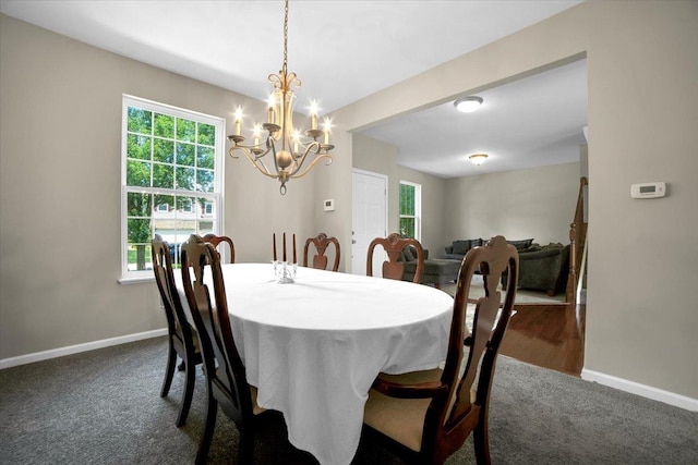 2585 Lambert Dr, Aurora, IL 60503 - dining room with dark carpet and a chandelier