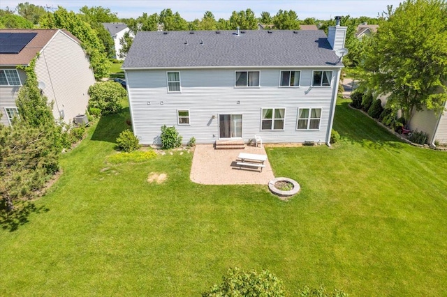 2585 Lambert Dr, Aurora, IL 60503 - back of house with a patio, a chimney, and a lawn