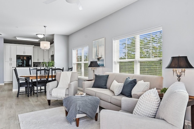 3975 Idlewild Ln Unit 200, Naperville, IL 60564 - living room featuring light wood-type flooring, a ceiling fan, and baseboards