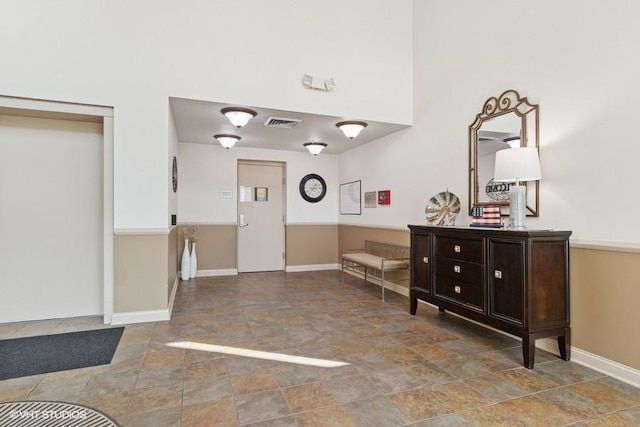 3975 Idlewild Ln Unit 200, Naperville, IL 60564 - foyer featuring stone finish flooring, baseboards, and a high ceiling
