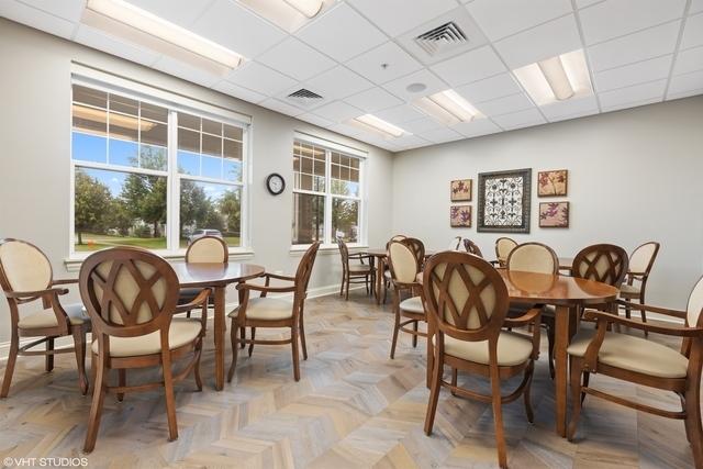 3975 Idlewild Ln Unit 200, Naperville, IL 60564 - dining room featuring healthy amount of natural light, baseboards, and a paneled ceiling