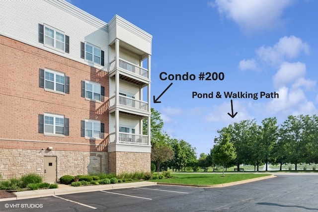 3975 Idlewild Ln Unit 200, Naperville, IL 60564 - view of apartment building / complex featuring uncovered parking