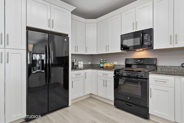 3975 Idlewild Ln Unit 200, Naperville, IL 60564 - kitchen featuring black appliances, light wood finished floors, white cabinets, and dark stone countertops