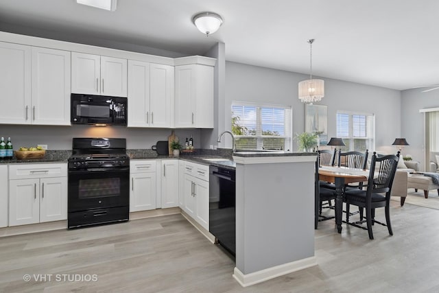 3975 Idlewild Ln Unit 200, Naperville, IL 60564 - kitchen with black appliances, a sink, white cabinets, and a peninsula