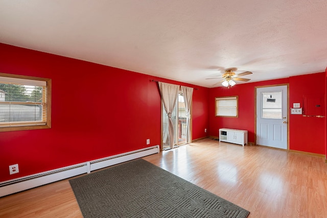 10608 Moody Ave, Chicago Ridge, IL 60415 - empty room with a baseboard heating unit, wood finished floors, a ceiling fan, and baseboards