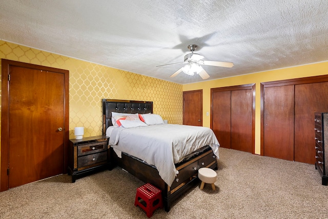 10608 Moody Ave, Chicago Ridge, IL 60415 - bedroom with carpet flooring, multiple closets, wallpapered walls, a textured ceiling, and a ceiling fan