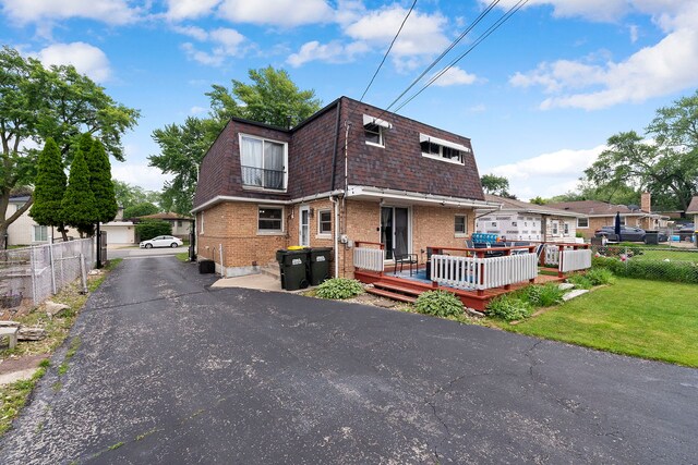 10608 Moody Ave, Chicago Ridge, IL 60415 - view of front of property with brick siding, a wooden deck, and mansard roof