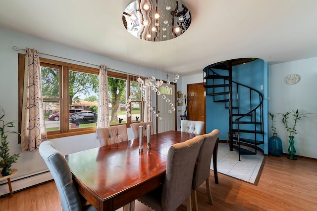 10608 Moody Ave, Chicago Ridge, IL 60415 - dining room with a chandelier, a baseboard radiator, stairs, and light wood-type flooring