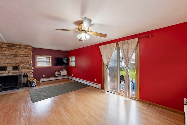 10608 Moody Ave, Chicago Ridge, IL 60415 - unfurnished living room featuring a baseboard heating unit, wood finished floors, ceiling fan, and a fireplace