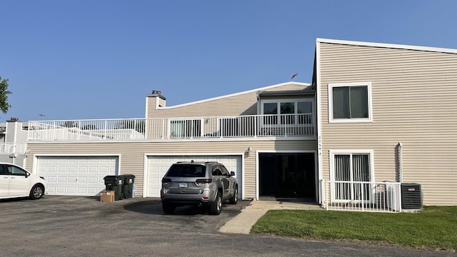 2254 N Baldwin Way Unit 4A, Palatine, IL 60074 - back of house with a balcony, driveway, and a chimney