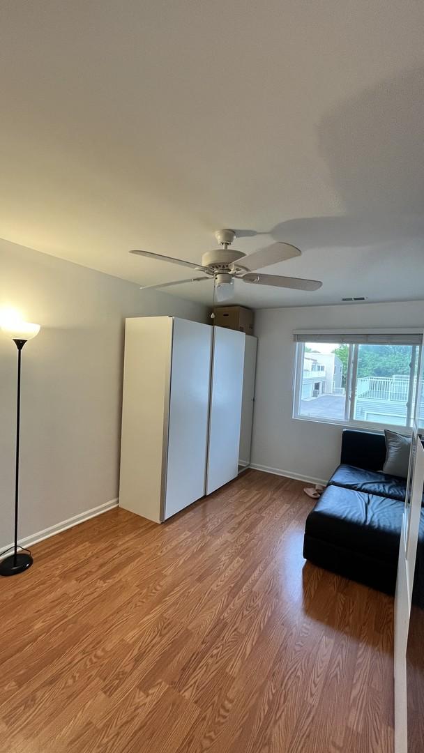 2254 N Baldwin Way Unit 4A, Palatine, IL 60074 - bedroom featuring light wood-style flooring and ceiling fan