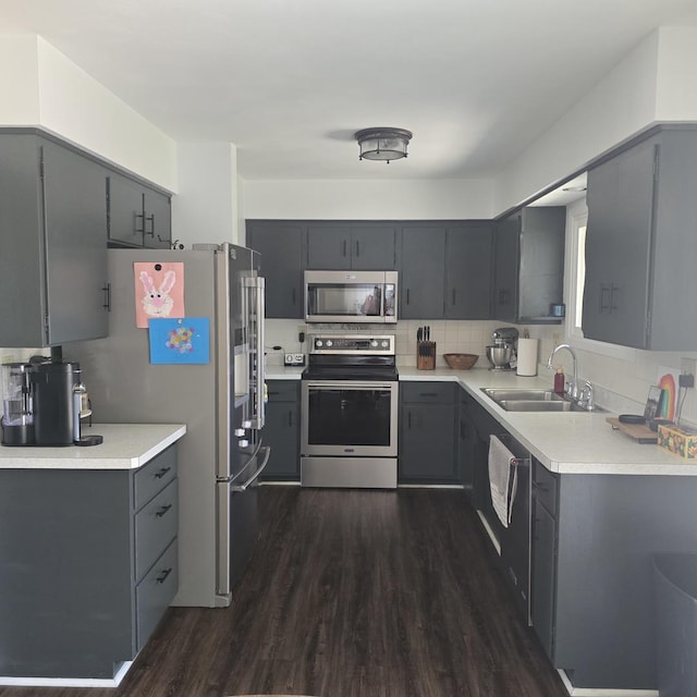 421 W 1st St, Stillman Valley, IL 61084 - kitchen with stainless steel appliances, a sink, gray cabinetry, and dark wood-style flooring