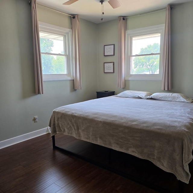 421 W 1st St, Stillman Valley, IL 61084 - bedroom featuring multiple windows, baseboards, dark wood-style flooring, and ceiling fan