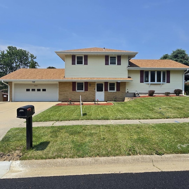 421 W 1st St, Stillman Valley, IL 61084 - tri-level home with a garage, driveway, and a front yard