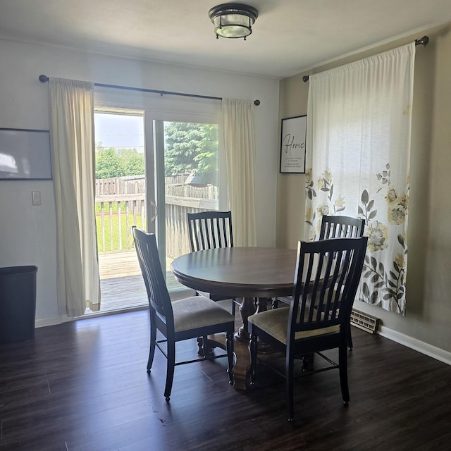 421 W 1st St, Stillman Valley, IL 61084 - dining space featuring dark wood-type flooring and baseboards