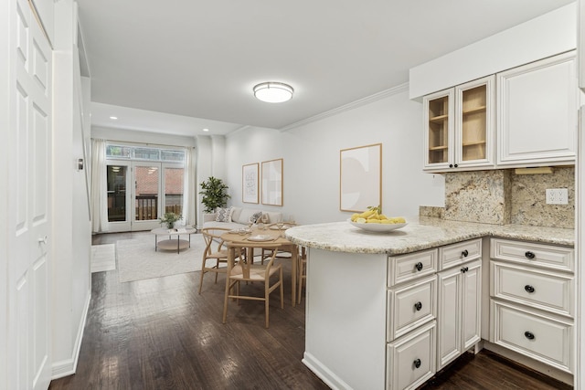 1443 W Wrightwood Ave Unit B, Chicago, IL 60614 - kitchen with glass insert cabinets, backsplash, dark wood-type flooring, a peninsula, and light stone countertops