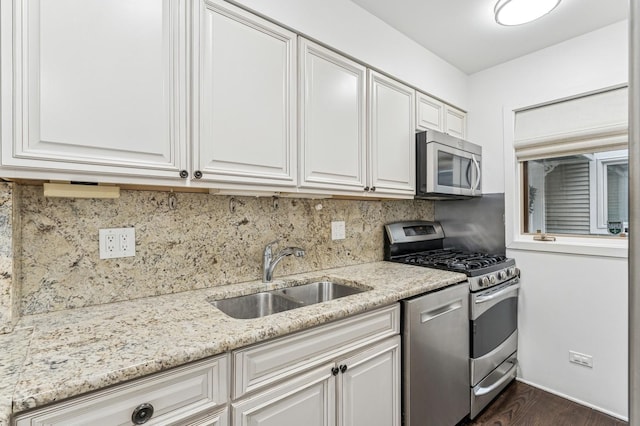 1443 W Wrightwood Ave Unit B, Chicago, IL 60614 - kitchen with appliances with stainless steel finishes, a sink, light stone counters, and dark wood finished floors