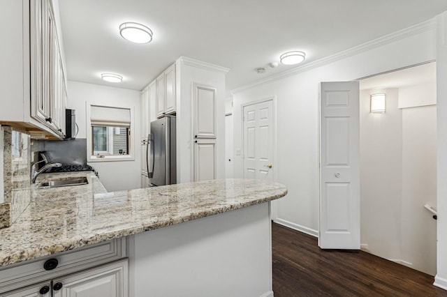 1443 W Wrightwood Ave Unit B, Chicago, IL 60614 - kitchen featuring appliances with stainless steel finishes, dark wood-style flooring, light stone countertops, ornamental molding, and white cabinets