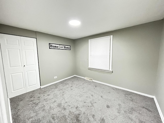 16612 Ashland Ave, Markham, IL 60428 - unfurnished bedroom featuring baseboards, carpet flooring, and a closet
