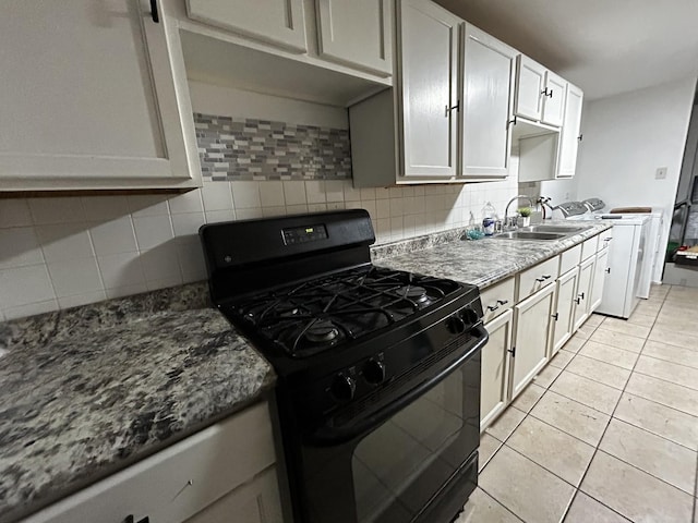 16612 Ashland Ave, Markham, IL 60428 - kitchen with black range with gas cooktop, a sink, backsplash, light tile patterned floors, and washing machine and dryer