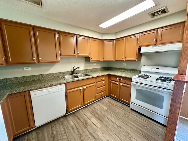 814 Spruce Ct, Streamwood, IL 60107 - kitchen featuring white appliances, under cabinet range hood, light wood-type flooring, and brown cabinetry