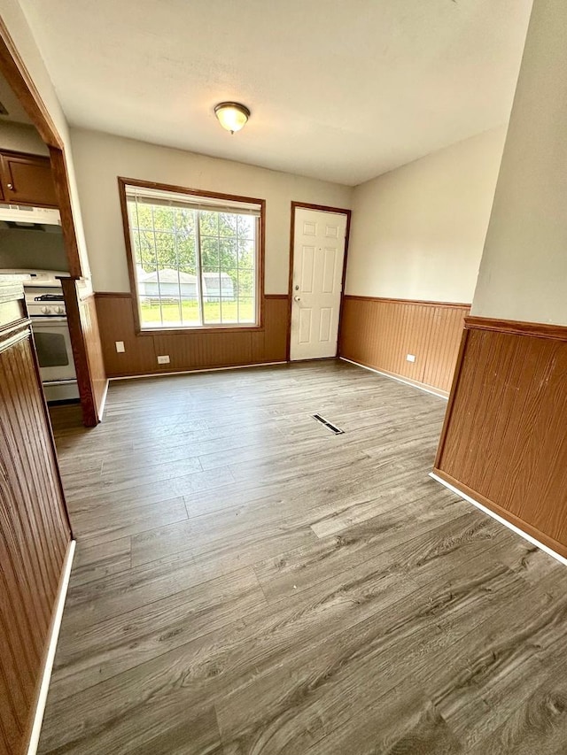 814 Spruce Ct, Streamwood, IL 60107 - unfurnished dining area featuring a wainscoted wall, wood finished floors, and wooden walls