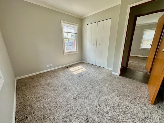814 Spruce Ct, Streamwood, IL 60107 - unfurnished bedroom featuring carpet flooring, crown molding, and a closet