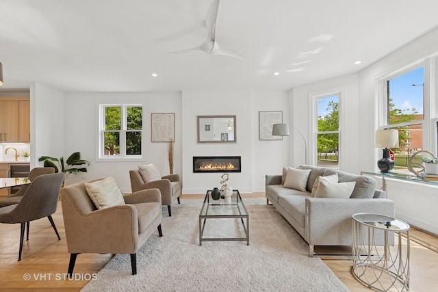 3300 S Giles Ave, Chicago, IL 60616 - living room featuring light wood finished floors, healthy amount of natural light, recessed lighting, a glass covered fireplace, and a ceiling fan