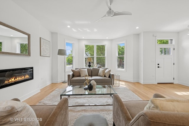 3300 S Giles Ave, Chicago, IL 60616 - living room featuring plenty of natural light, a glass covered fireplace, light wood-style floors, recessed lighting, and a ceiling fan