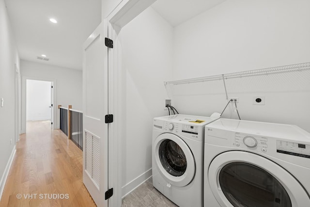 3300 S Giles Ave, Chicago, IL 60616 - washroom with washing machine and clothes dryer, light wood-style floors, and recessed lighting