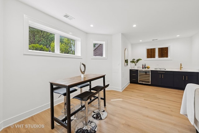 3300 S Giles Ave, Chicago, IL 60616 - bar area featuring beverage cooler, light wood-style flooring, and recessed lighting
