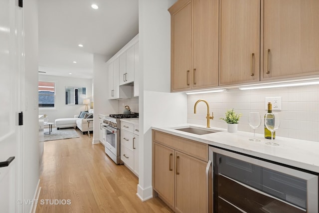 3300 S Giles Ave, Chicago, IL 60616 - kitchen with high end range, beverage cooler, light wood-style floors, light brown cabinetry, and recessed lighting