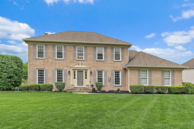 1560 Kensington Dr, Algonquin, IL 60102 - colonial-style house with a front yard, brick siding, and roof with shingles
