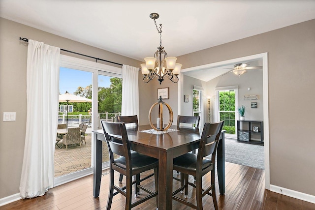 1560 Kensington Dr, Algonquin, IL 60102 - dining area featuring a chandelier, dark wood finished floors, baseboards, ceiling fan, and vaulted ceiling