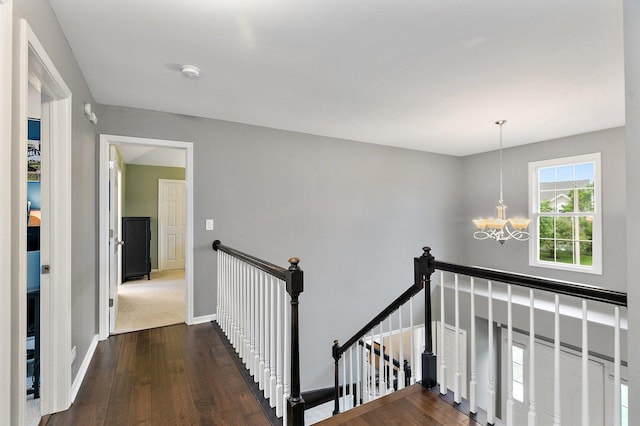 1560 Kensington Dr, Algonquin, IL 60102 - hallway featuring an upstairs landing, a chandelier, dark wood-style flooring, and baseboards