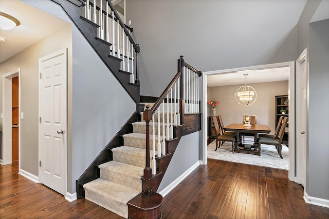 1560 Kensington Dr, Algonquin, IL 60102 - stairway with wood-type flooring, baseboards, and a chandelier