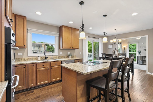1560 Kensington Dr, Algonquin, IL 60102 - kitchen with a sink, black electric stovetop, plenty of natural light, a kitchen bar, and recessed lighting