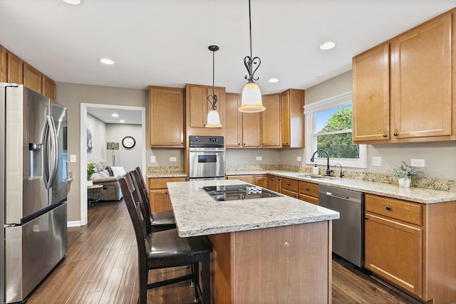 1560 Kensington Dr, Algonquin, IL 60102 - kitchen featuring appliances with stainless steel finishes, a sink, a center island, dark wood-style flooring, and a kitchen bar