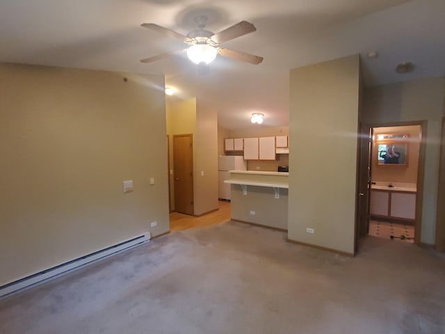 430 Cunat Blvd Unit 3C, Richmond, IL 60071 - unfurnished living room featuring a baseboard heating unit, ceiling fan, light carpet, and baseboards