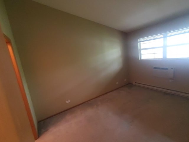 430 Cunat Blvd Unit 3C, Richmond, IL 60071 - unfurnished room featuring a wall mounted AC, a baseboard radiator, and light colored carpet