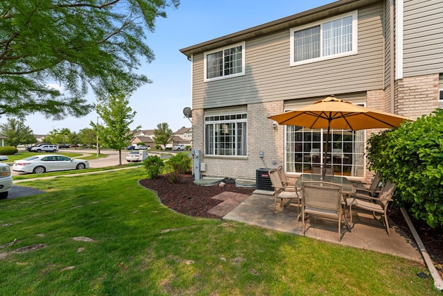 7008 Century Ct, Tinley Park, IL 60477 - rear view of house with brick siding, a yard, a patio, and central AC