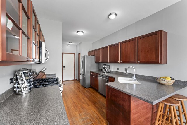 7008 Century Ct, Tinley Park, IL 60477 - kitchen with a sink, stainless steel appliances, dark countertops, and a peninsula