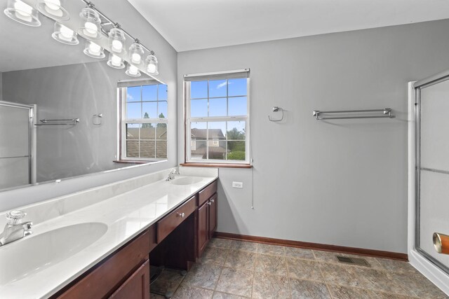 7008 Century Ct, Tinley Park, IL 60477 - bathroom with baseboards, a shower stall, double vanity, and stone finish flooring