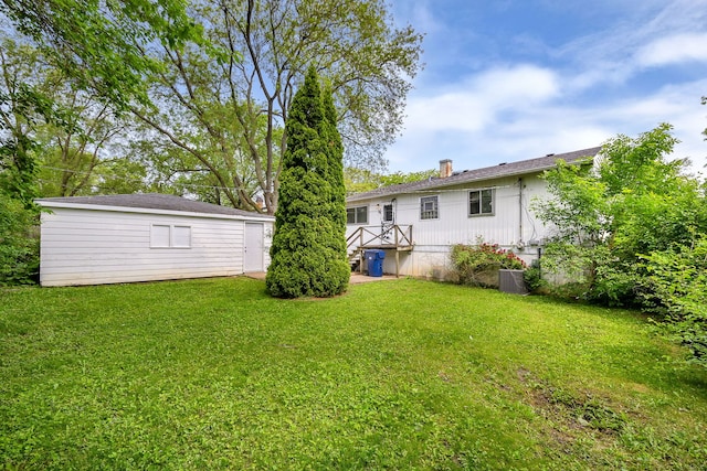 323 Mark Ave, Glendale Heights, IL 60139 - view of grassy yard featuring central air condition unit and an outbuilding