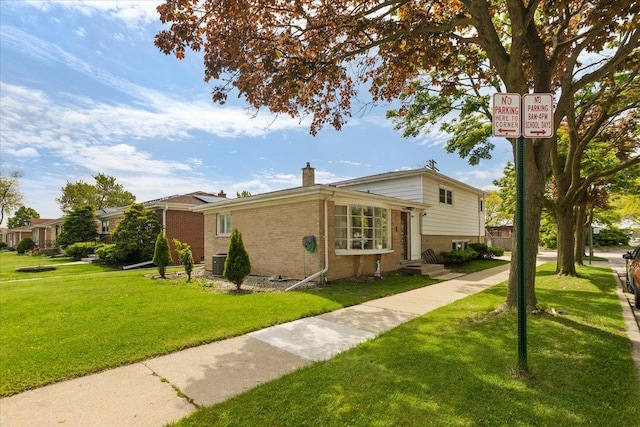 8353 N Drake Ave, Skokie, IL 60076 - view of side of home featuring a chimney, brick siding, a yard, and central AC