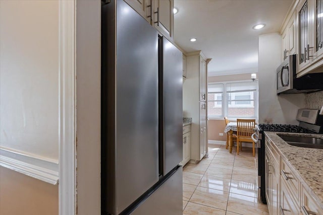 8353 N Drake Ave, Skokie, IL 60076 - kitchen featuring appliances with stainless steel finishes, crown molding, light stone countertops, recessed lighting, and baseboards