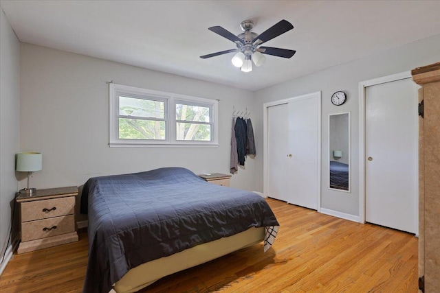8353 N Drake Ave, Skokie, IL 60076 - bedroom with wood finished floors, two closets, ceiling fan, and baseboards