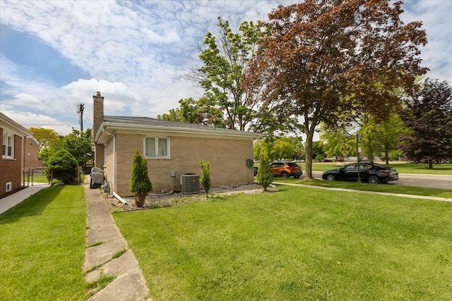 8353 N Drake Ave, Skokie, IL 60076 - view of side of home featuring a chimney, brick siding, a lawn, and central air condition unit