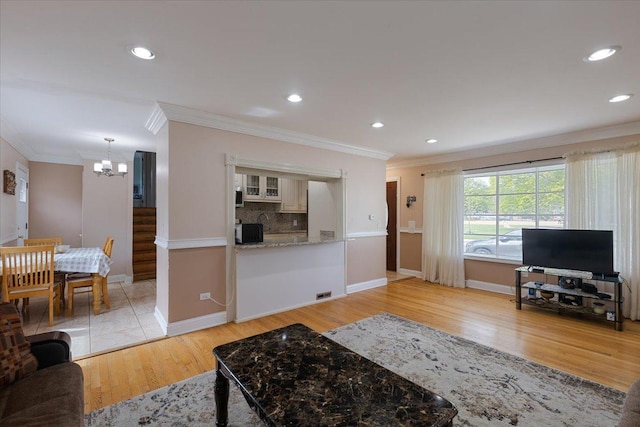 8353 N Drake Ave, Skokie, IL 60076 - living room with a chandelier, crown molding, light wood-style floors, baseboards, and recessed lighting