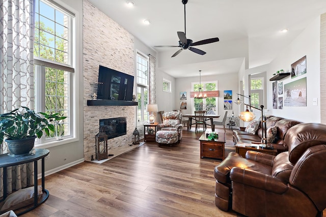 20142 Crystal Lake Way, Frankfort, IL 60423 - living area featuring wood finished floors, a stone fireplace, ceiling fan, recessed lighting, and a chandelier